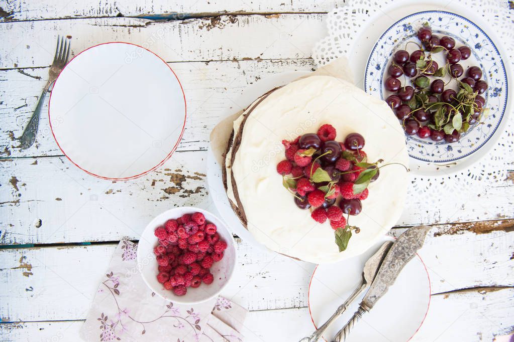 Cocoa Sponge Cake with Whipped Cream and Raspberries, cherries -