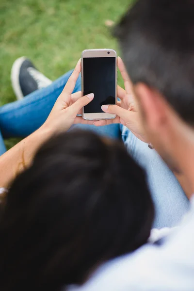 Detail of couple using smartphone together — Stockfoto