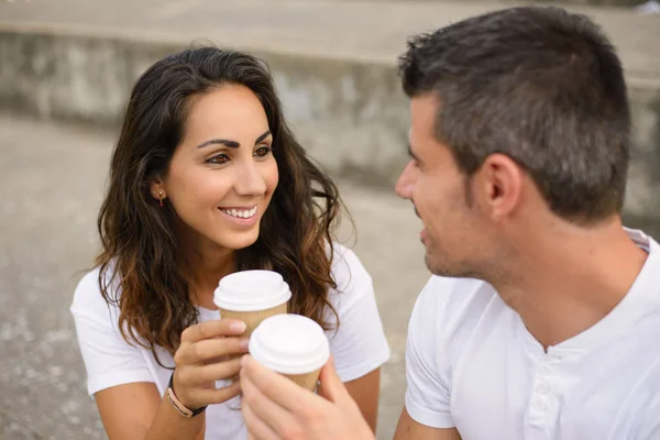 Happy young couple dating and drinking coffee outside — Stock Photo, Image
