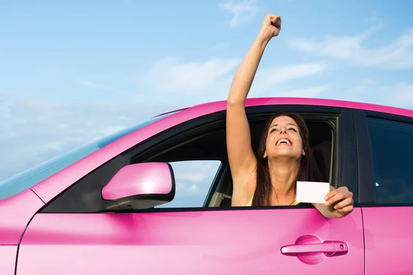 Successful woman holding driver license in her car — Stock Photo, Image