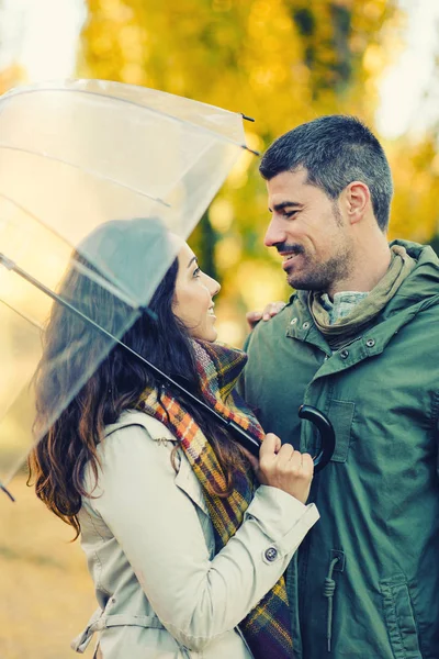 Joven pareja encantadora coqueteando en otoño a pie en el parque — Foto de Stock