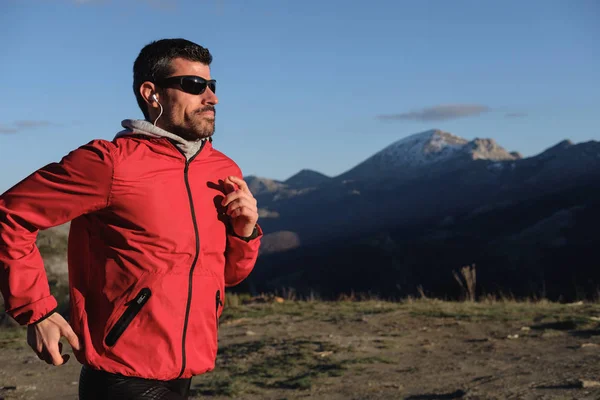 Atleta corriendo a través del país en la montaña — Foto de Stock