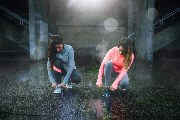 Dos corredores listos para entrenar bajo la lluvia — Foto de Stock