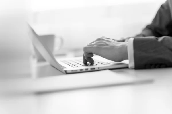 Businessman typing data on a laptop computer — Stock Photo, Image