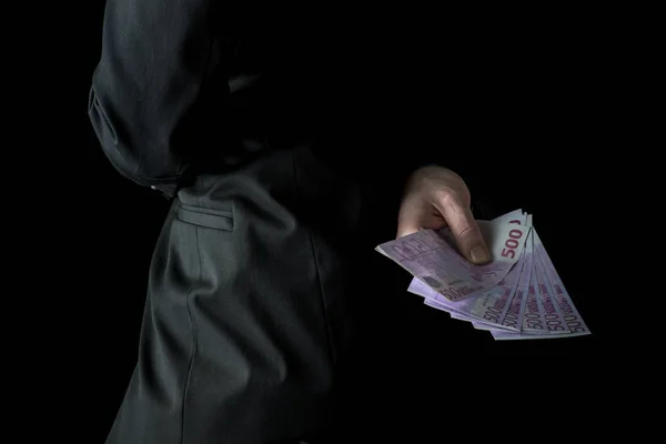 Businessman holding 500 euro banknotes behind his back — Stock Photo, Image