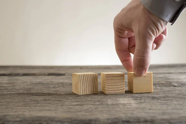 Three wooden empty blocks being placed on a rustic table — Stock Photo, Image