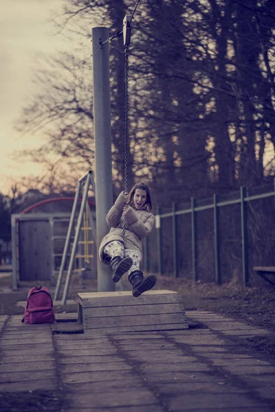 Woman having fun on a swing outdoors — Stock Photo, Image