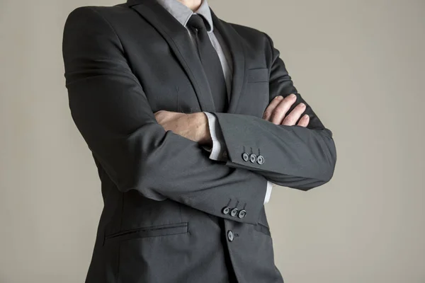 Torso of a businessman standing with folded arms — Stock Photo, Image