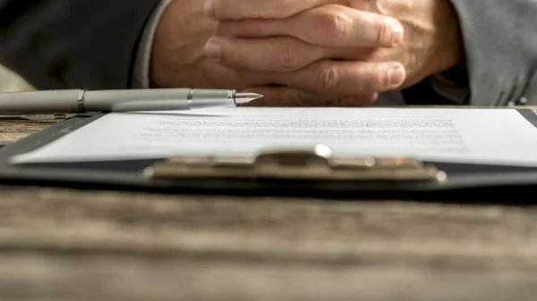 Businessman in a meeting with clasped hands — Stock Photo, Image