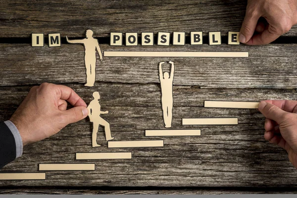 People making impossible letter tile sign into possible — Stock Photo, Image