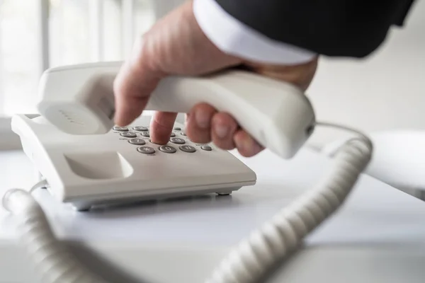 Businessman dialing a telephone number — Stock Photo, Image