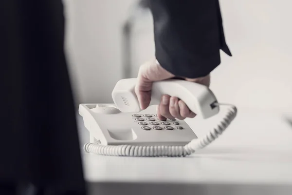 Retro toned image of a businessman dialing telephone number — Stock Photo, Image