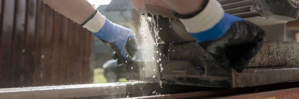 Low angle view of an angle grinder or circular saw cutting a con — Stock Photo, Image