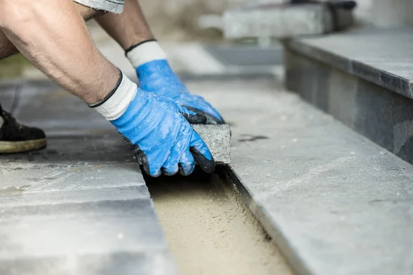 Contractor laying new paving bricks or stones — Stock Photo, Image