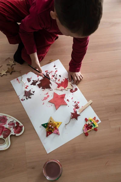 Giovane ragazzo pittura fatti in casa decorazioni di Natale — Foto Stock
