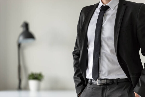 Business man in his office with his hands in the pockets of his 