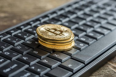 Altın Bitcoins yığını ile siyah klavye