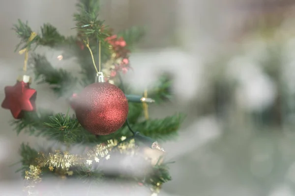 Red bauble hanging on a Christmas tree — Stock Photo, Image
