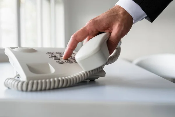 Male hand dialing a telephone number in order to make a phone ca — Stock Photo, Image
