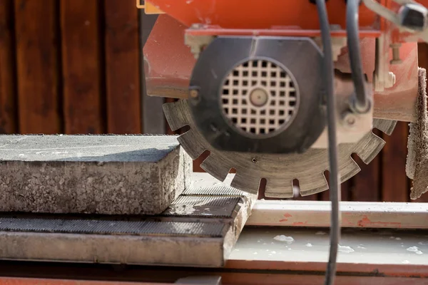 Concrete block and an angle grinder — Stock Photo, Image
