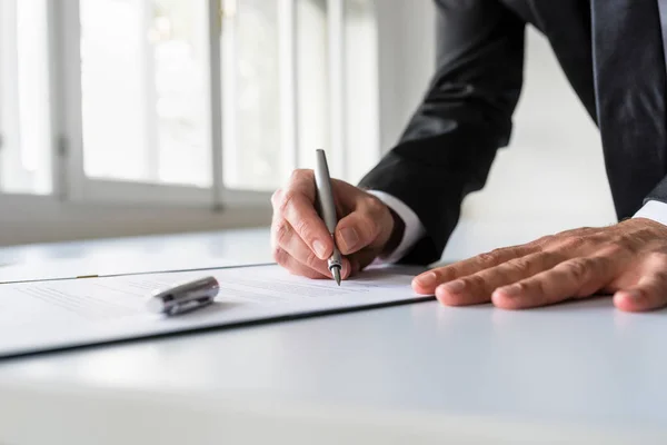Affärsman i office underteckna kontrakt — Stockfoto