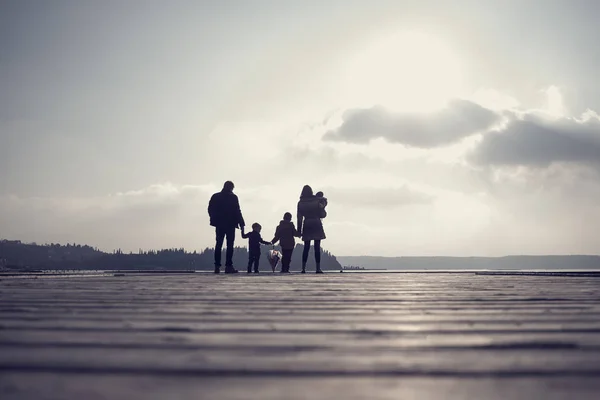 Retro toned image of family with mother, father, two kids and a