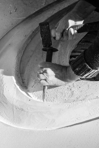 Monochrome image of an artist carving in stone — Stock Photo, Image