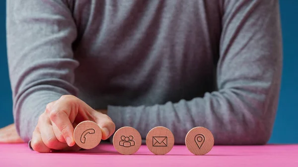 Man placing four wooden cut circles with contact and communicati — ストック写真