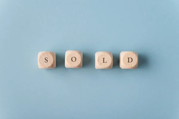 Sold sign on wooden dices — Stock Photo, Image