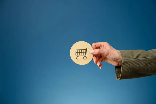 Female Hand Holding Wooden Cut Circle Shopping Cart Written Blue — Stock Photo, Image