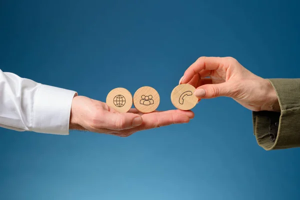 Female Hand Placing Three Wooden Cut Circles Contact Communication Icons — Stock Photo, Image