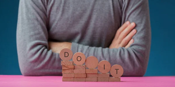 Man Sitting His Desk Sign Front Him Spelled Wooden Cut — Stock Photo, Image