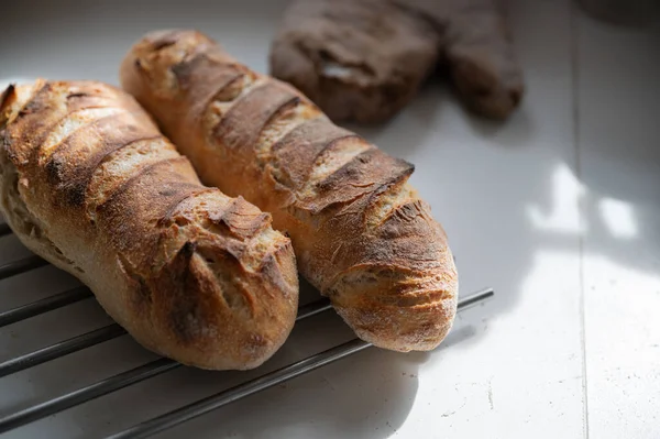 Two Freshyl Baked Delicious Baguettes Crunchy Golden Crust Cooling Rake — Stock Photo, Image