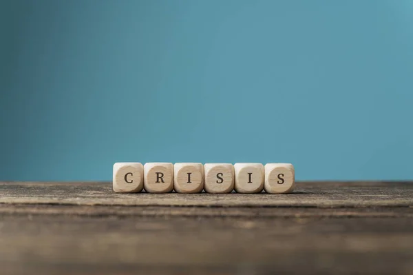 Word Crisis Spelled Wooden Dices Placed Desk Blue Background — Stock Photo, Image