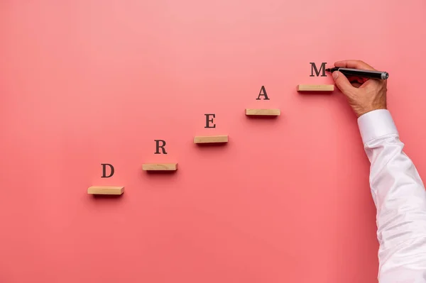 Businessman Writing Word Dream Wooden Pegs Placed Stairway Structure — Stock Photo, Image