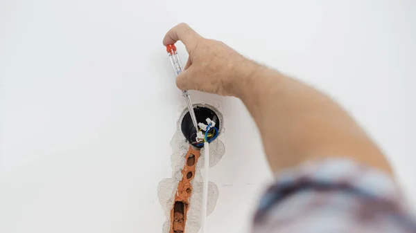 Closeup Electrician Checking Presence Electrical Current Wire Coming Wall — Stock Photo, Image