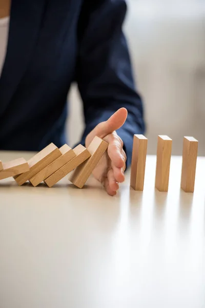 Closeup View Businesswoman Interrupting Collapsing Dominos Her Hand Conceptual Image — Stock Photo, Image