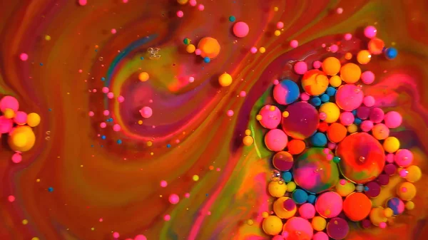Multi-colored bubbles in the water. Abstract rainbow drops, can be used as background. Vividly beautiful this image is an abstract macro depiction. Still life cosmetics photography. Overhead top down. colorful