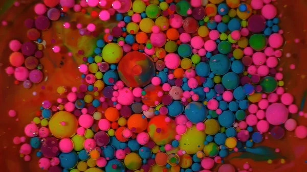 Multi-colored bubbles in the water. Abstract rainbow drops, can be used as background. Vividly beautiful this image is an abstract macro depiction. Still life cosmetics photography. Overhead top down. flavor