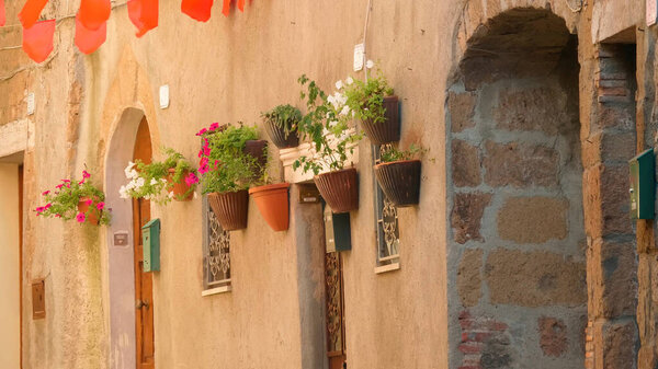 Tuscany, Italy. Flower pots on the wall.