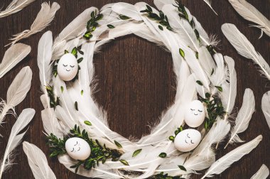 Mutlu Paskalyalar. Paskalya arkaplanını tebrik ederim. Ahşap arka planda beyaz tüylü Paskalya yumurtaları.