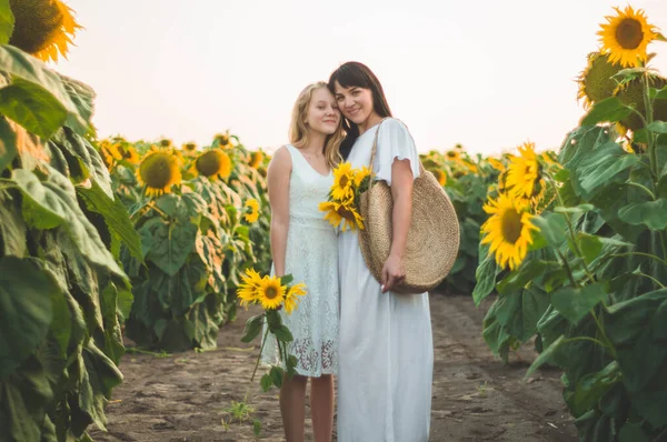 Glückliche Mutter und ihre Teenager-Tochter im Sonnenblumenfeld. Lebensstil im Freien Glück — Stockfoto