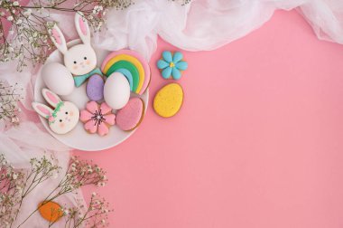 Mutlu Paskalyalar. Pembe arka planda çok renkli pastel paskalya kurabiyeleri.. 