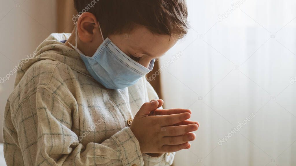 Coronavirus covid-19. Child praying to God requesting that the coronavirus covid 19 not spread beyond control. 