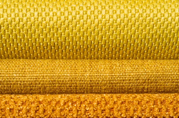 Catalogo di tessuto in tonalità giallo arancio. Campione di tessuto. Contesto industriale . — Foto Stock