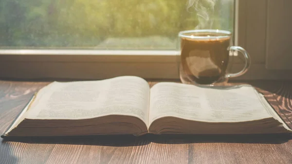 The Bible and cup coffee. Reading the bible.  Concept for faith, spirituality and religion