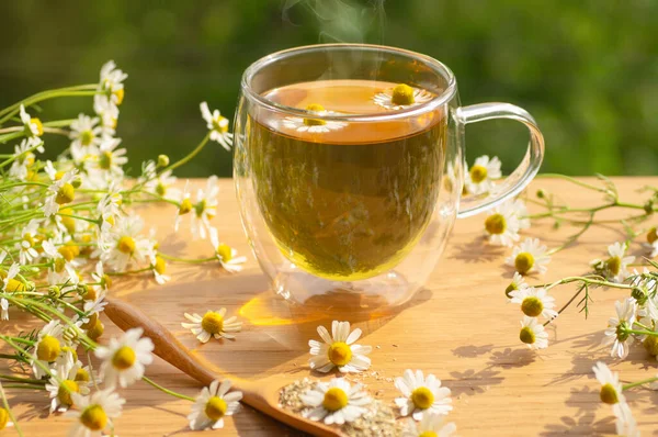 Chamomile flowers and chamomile tea. Herbal chamomile tea. Close-up.