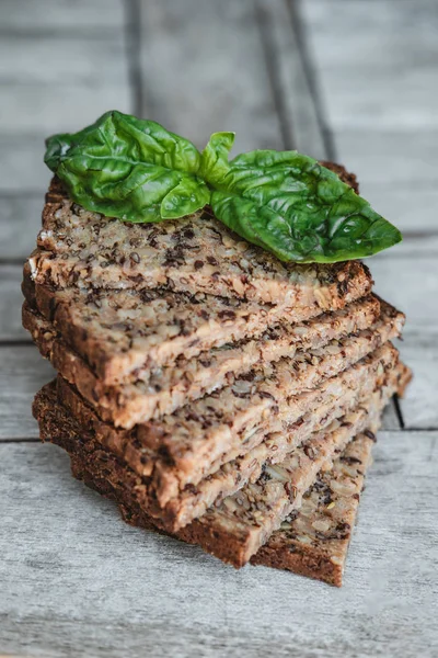 Fitness bread with  basil Leaf on rustic wood background, closeu — Stock Photo, Image