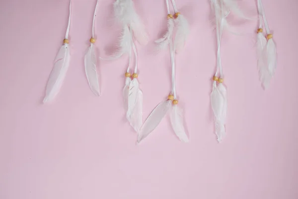 Spase for text. White dream catcher with feathers on a pink back — Stock Photo, Image