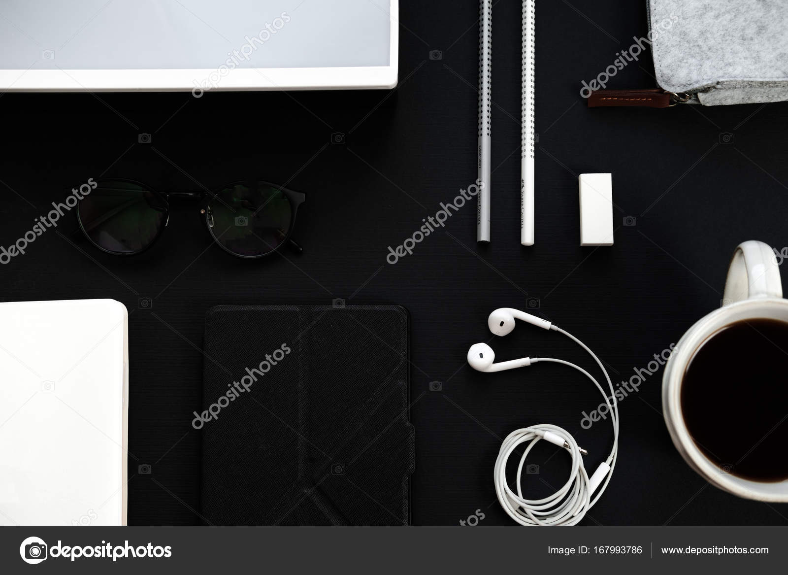 Black and white office table desk. Workspace with diary, plant, Stock